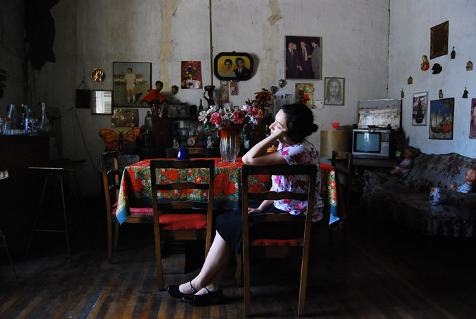 Lucía seated at a table in her home