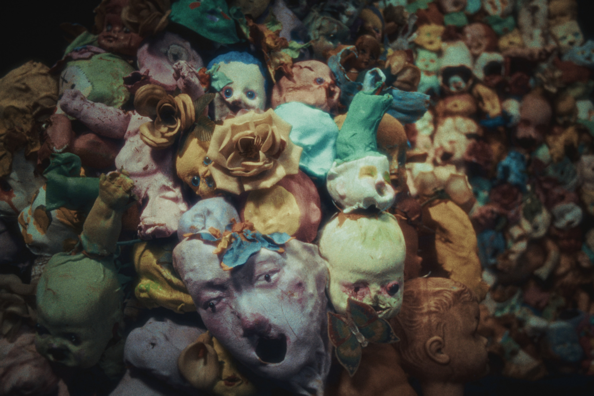 Merrimundi — a field of colourful sculpted faces and flowers